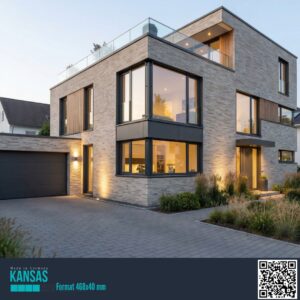 Modern brick house with large bay windows, warm interior lighting, and a two-car garage, set on a paved driveway with landscaped front.