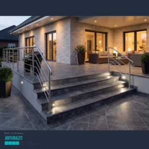 Modern brick house with illuminated outdoor stairs and a night-time patio seating area with stainless steel railings.