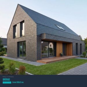 Modern two-story brick house with a steep pitched roof and a wooden entry deck overlooking a green lawn.